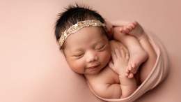 Sweet smiles for this newborn girl.